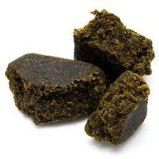 CBD Afghan Hash in dark brown color, showing the texture and consistency of the product on a white background