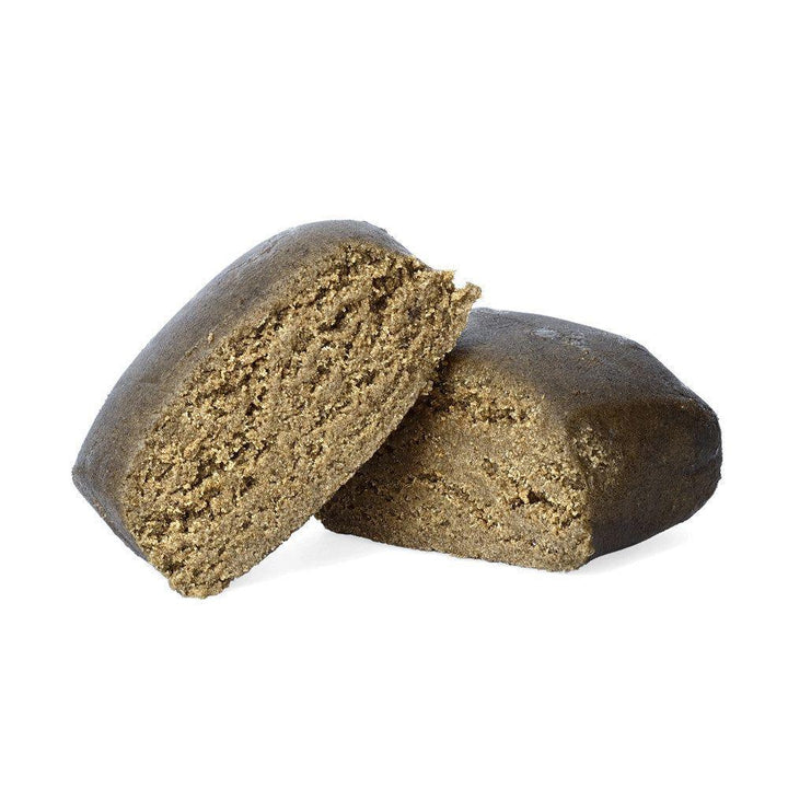 CBD Isolator Hash shown as a dark brown block, cut to reveal the textured interior. Front view on a white background