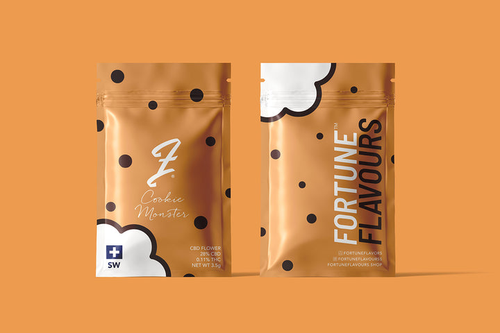Two packages of Cookie Monster CBD flower by FortuneFlavours, with brown branding on an orange background