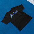 Load image into Gallery viewer, Fortune Flavours black t-shirt with a blue spell out logo in the front, birds eye view on a blue background
